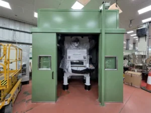 Side view of Bruderer press enclosure by Unitech Machinery with integrated access doors and safety interlocks.